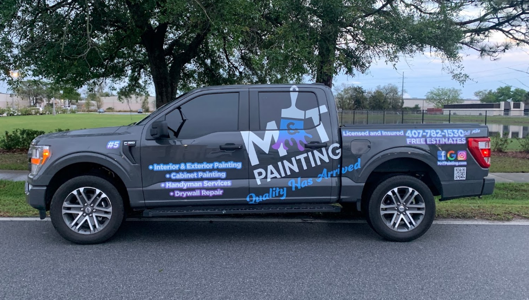 Installinng graphics on M & T Printing trailer in Orlando